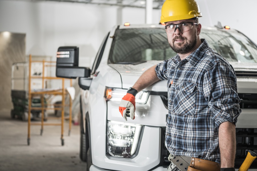 contractor standing next to a truck